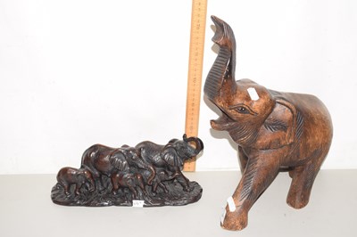 Lot 674 - A carved wooden elephant together with resin...