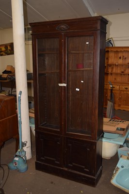 Lot 814 - Glazed bookcase over cupboards with moulded front