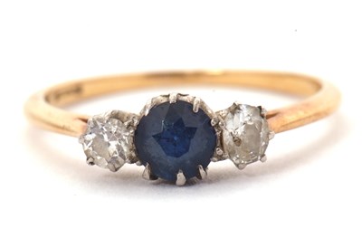 Lot 48 - A sapphire and diamond ring, the central round...