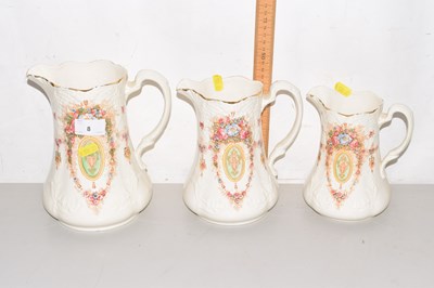 Lot 8 - A graduated set of three Devon ware jugs