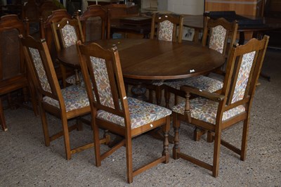 Lot 316 - An oak finish extending dining table and six...