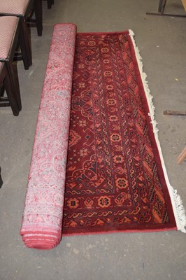 Lot 709 - A large red and orange ground geometric...