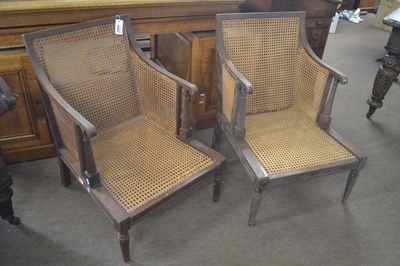 Lot 477 - A near pair of Georgian bergere armchairs with...