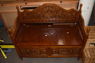 Lot 757 - A modern oak monk style bench with carved back...