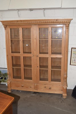 Lot 814 - A large pine cabinet with two glazed doors and...
