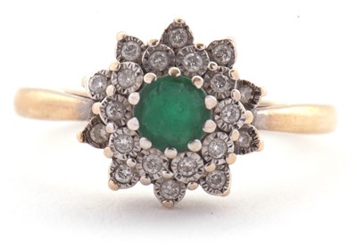 Lot 22 - An emerald and diamond cluster ring, set with...