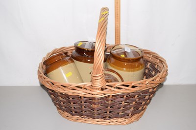 Lot 7 - Wicker basket containing kitchen storage jars