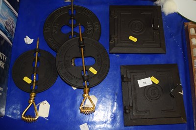 Lot 23 - Group of three cast iron stove dampers and two...