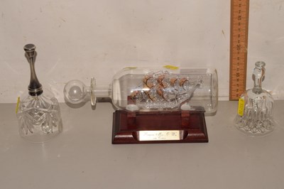 Lot 65 - A glass ship in a bottle together with two...