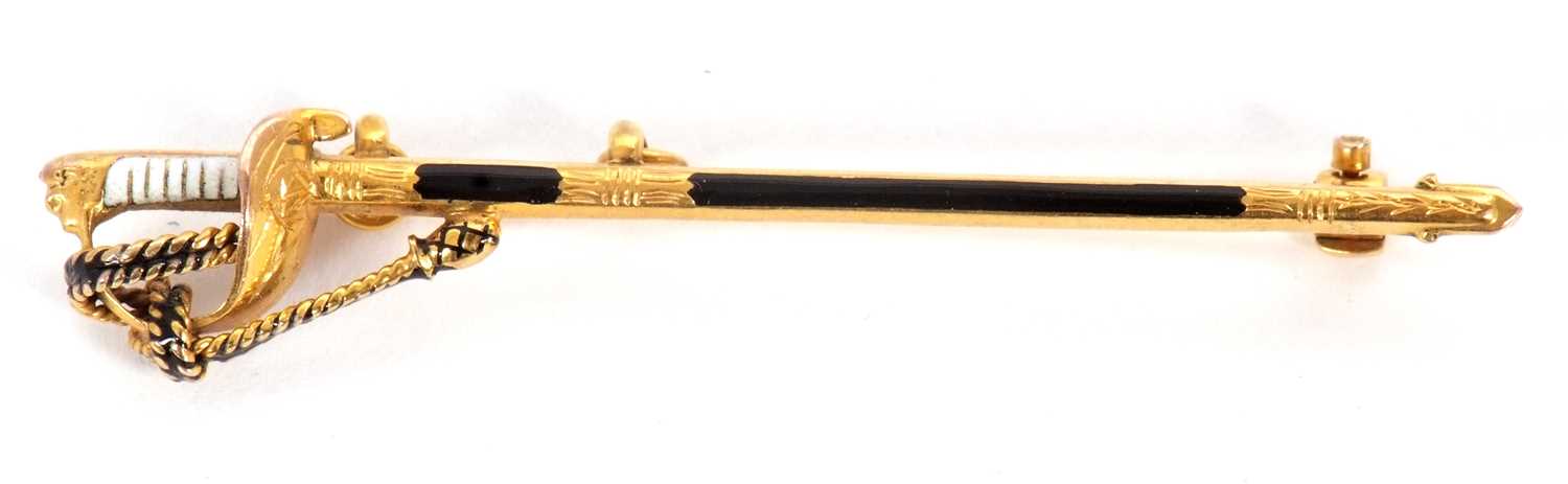 Lot 90 - A 9ct sword brooch, the sword with black...