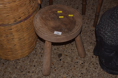 Lot 305 - A milking stool