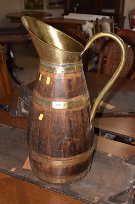 Lot 315 - A large wood and brass mounted jug