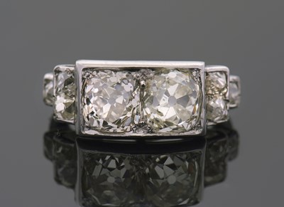 Lot 302 - A diamond ring, set with two old mine cut...