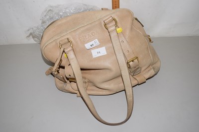 Lot 71 - A beige handbag bearing label Prada, worn...