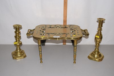 Lot 156 - A brass trivet and two brass candlesticks