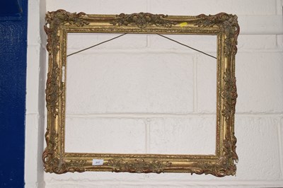 Lot 217 - A rectangular gilt picture frame with foliate...