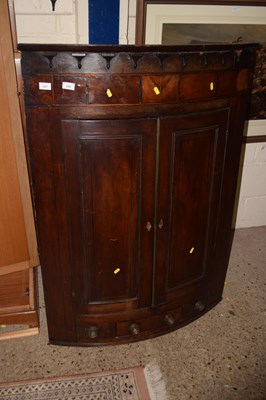Lot 227 - A Georgian mahogany bow front two door corner...