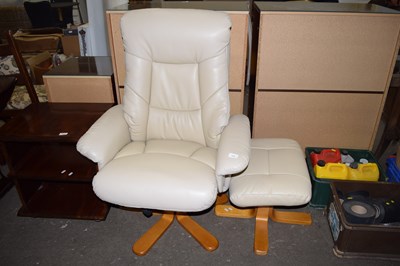 Lot 733 - A cream leather recliner chair and footstool