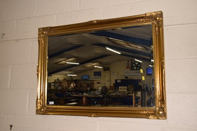 Lot 212 - Modern bevelled wall mirror in a gilt finish...