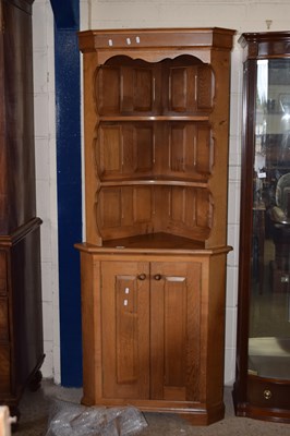 Lot 222 - A 20th Century oak corner cabinet formed of...