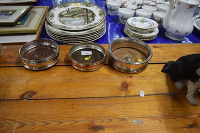 Lot 192 - Three silver plated bottle stands