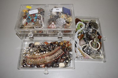 Lot 102 - A small plastic cabinet containing costume...