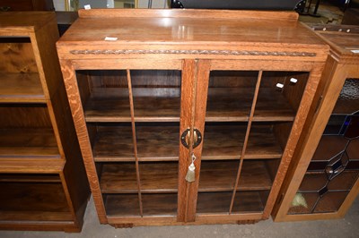 Lot 695 - An early 20th Century oak bookcase or display...