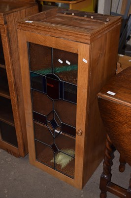 Lot 696 - A 20th Century cabinet with lead glazed door