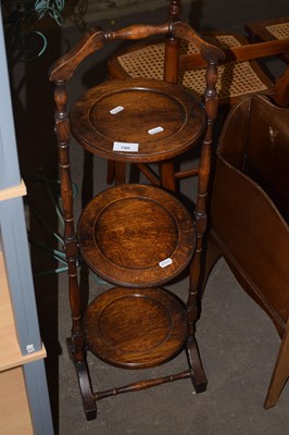 Lot 700 - An early 20th Century folding oak cake stand