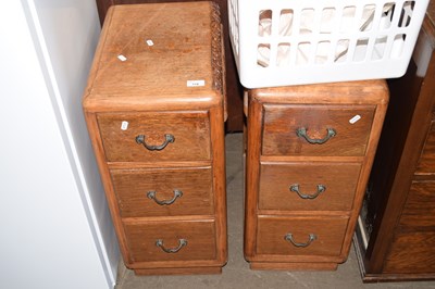 Lot 718 - A pair of oak three drawer chests