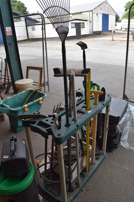 Lot 340 - A plastic garden tool stand with various tools,...