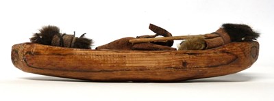 Lot 203 - An Inuit carved wooden canoe with paddles,...