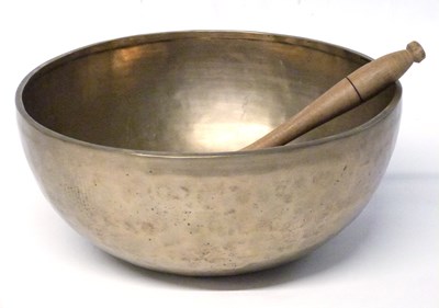 Lot 212 - A Tibetan singing brass bowl with wooden club,...