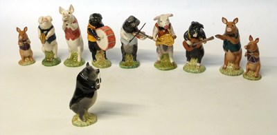 Lot 247 - A group of Beswick pig promenade band figures,...