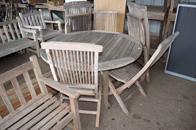 Lot 372 - A wooden garden table together with six...