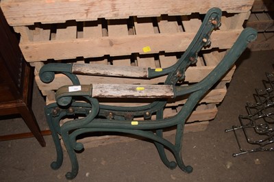 Lot 791 - A pair of green painted cast iron bench ends