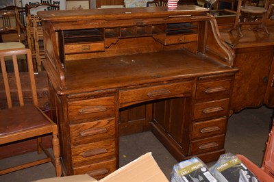 Lot 807 - An early 20th Century oak roll top desk