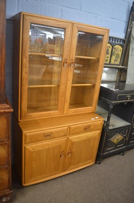 Lot 338 - An Ercol light elm display cabinet formed of...