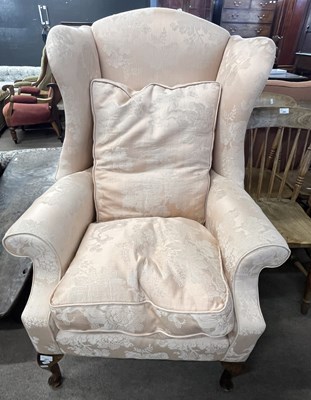 Lot 383 - A 20th Century wing back armchair in the...