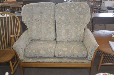 Lot 413 - An Ercol light elm two seater sofa with loose...