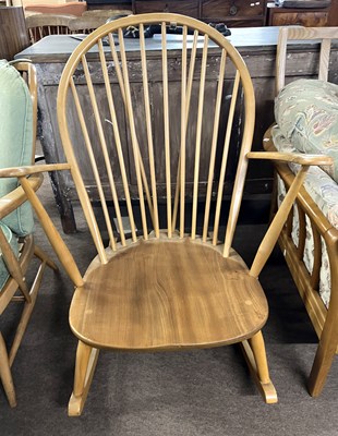 Lot 414 - An Ercol light elm stick back rocking chair,...