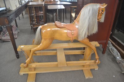 Lot 454 - A 20th Century polished wood rocking horse on...