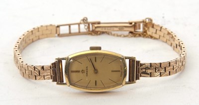 Lot 180 - A ladies Omega watch on a 9ct gold bracelet,...