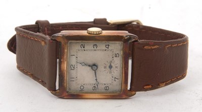 Lot 192 - A yellow metal square cased gents watch...