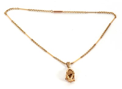 Lot 165 - A fish pendant necklace, the stylised filigree...