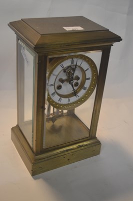 Lot 493 - A brass eight day four glass clock