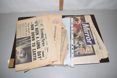 Lot 57 - A folder of vintage newspapers to include moon...