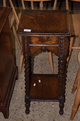 Lot 277 - An early 20th Century oak plant stand on...
