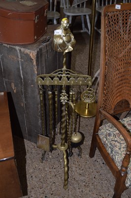 Lot 329 - A brass fire companion set