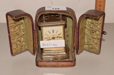 Lot 125 - A miniature carriage clock produced by Ansonia...